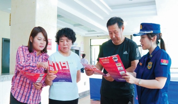中秋、国庆“双节”假期,丹东市消防救援支队边境经济合作区消防救援大队宣传员杨彬彬(右一)深入辖区街道进行入户讲解。(摄影:赵福来)